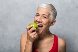 Older woman eating an apple 23226 Dentist